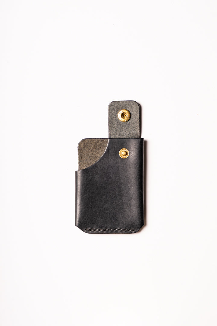 Two-tone leather wallet with metal clasps on a white background